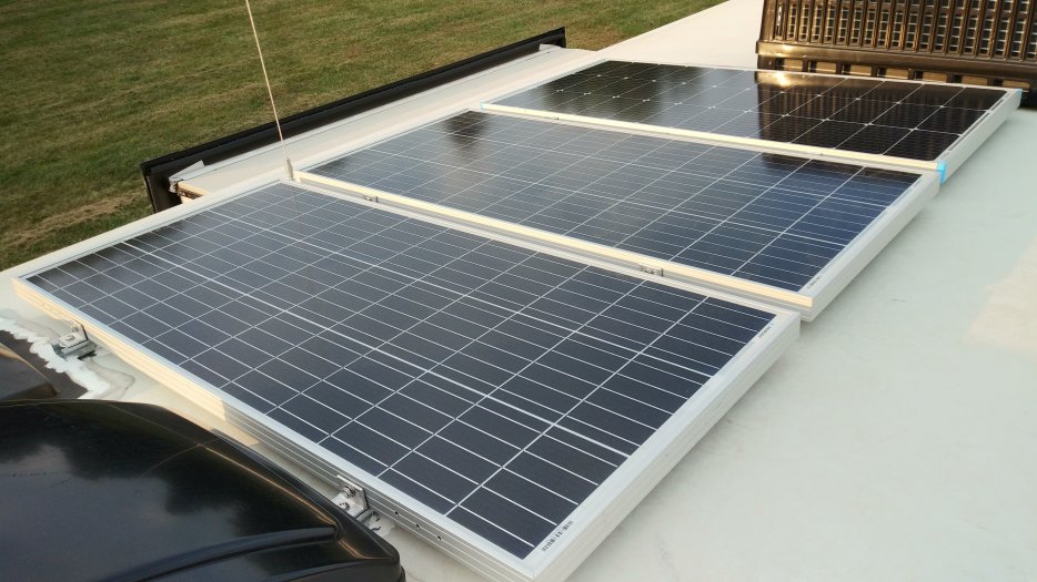 I have three 100W Renogy panels on struts.  The panels are shifted street side so I have a path to walk forward on the roof.  The struts are screwed down with eternabond-wrapped spacers so water can escape under the struts.  As of posting this photo I don't yet have wiring down to the battery.  For now I use an SAE adapter and toss a wire over the side to connect to my Victron 100/30 solar controller via repurposing (properly) the SAE zamp connector in the 2019 model year.